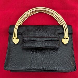 Meyers Elegant Black Handbag with Gold Accents that has 3 bars on each side (mlb